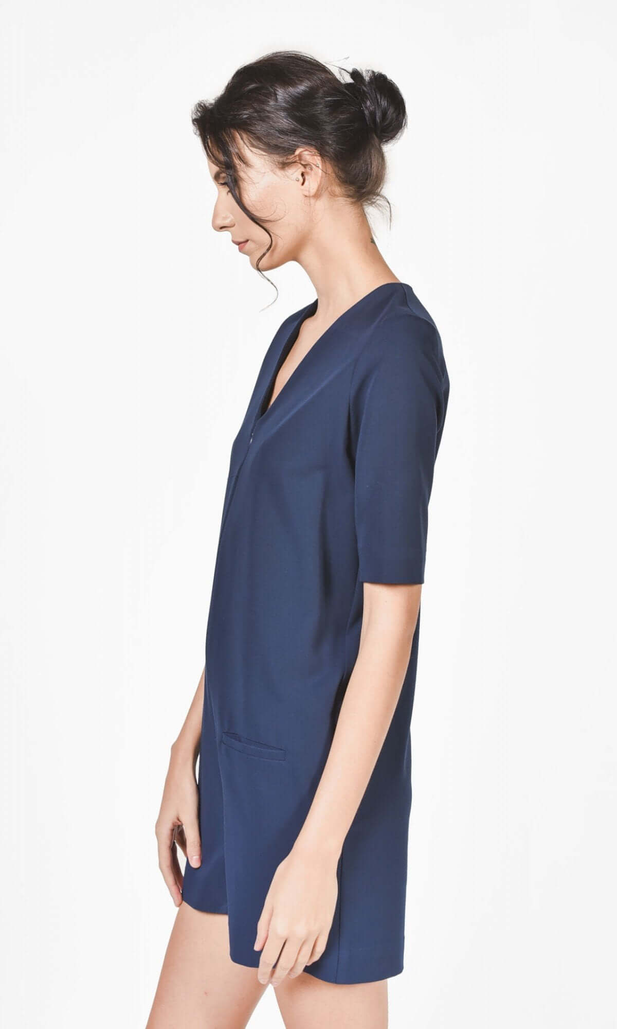 Side view of the navy jumpsuit showing fitted silhouette