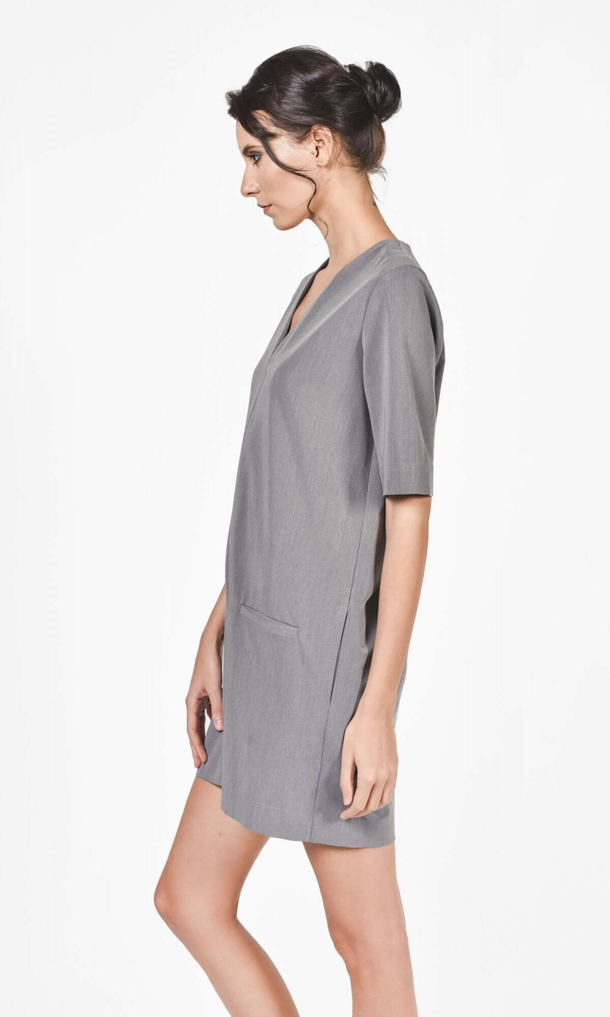side view of the grey short jumpsuit short sleeves showing fitted silhouette