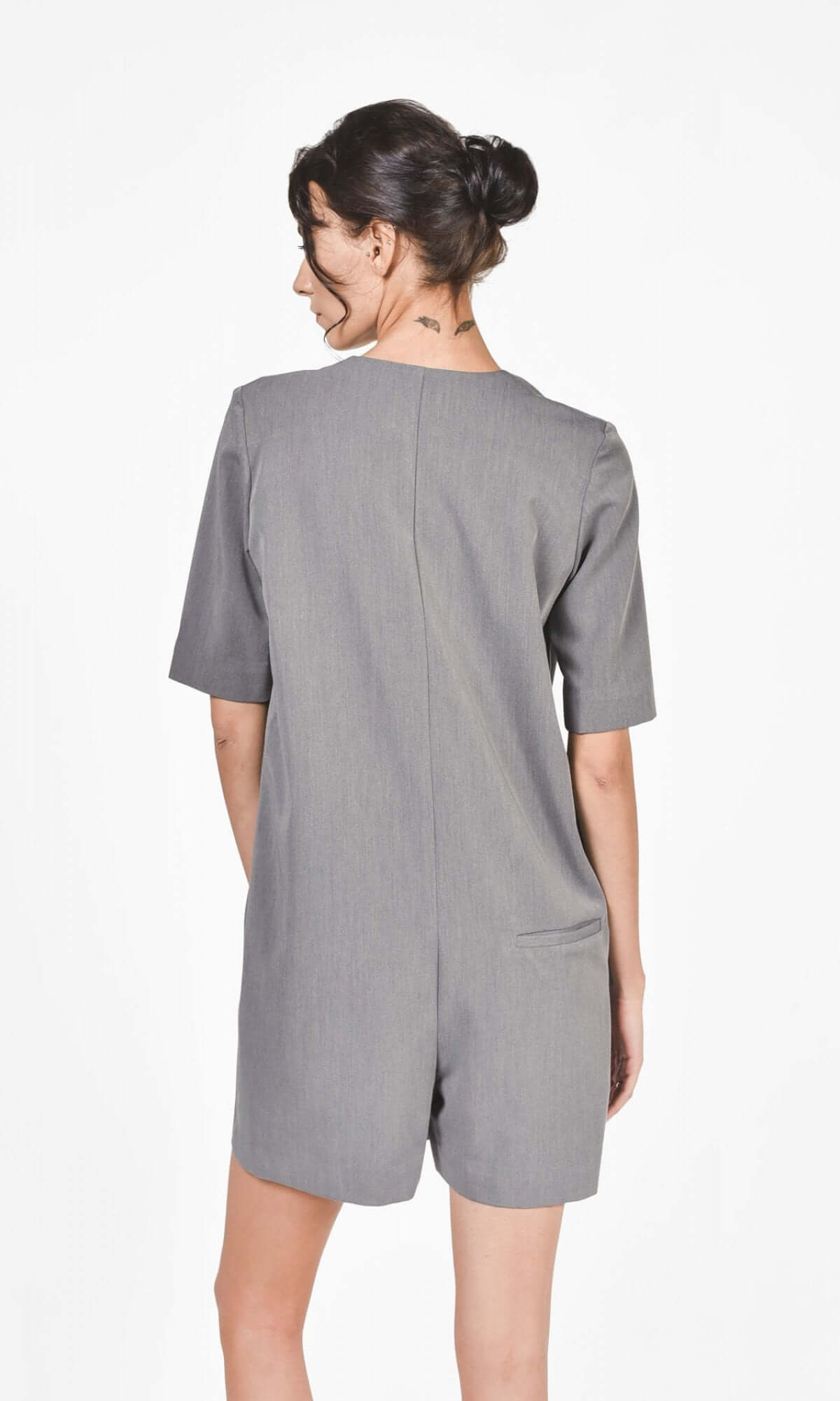 back side of grey jumpsuit showing straight fitted silhouette