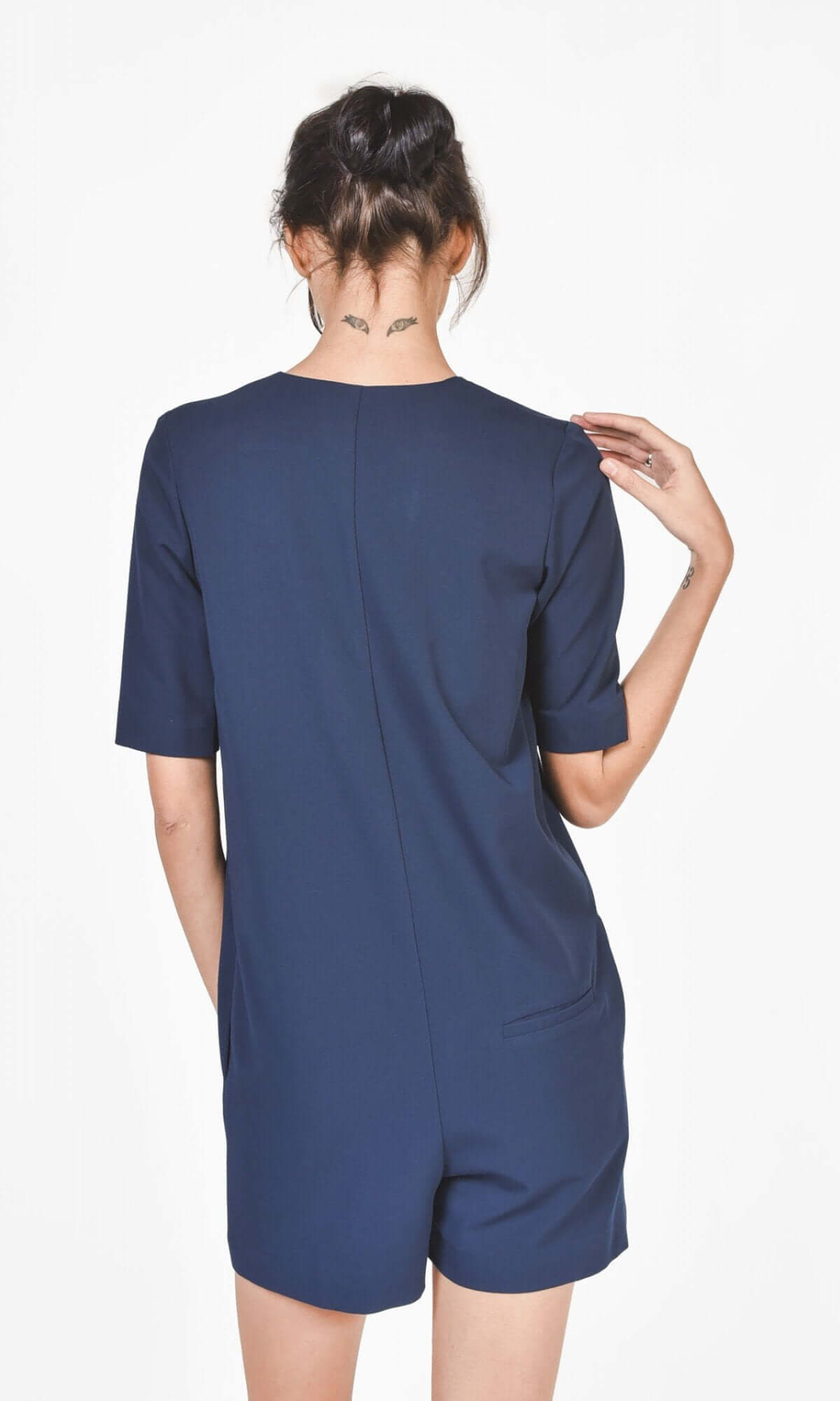 Back view of navy jumpsuit showing hidden back pocket on right side