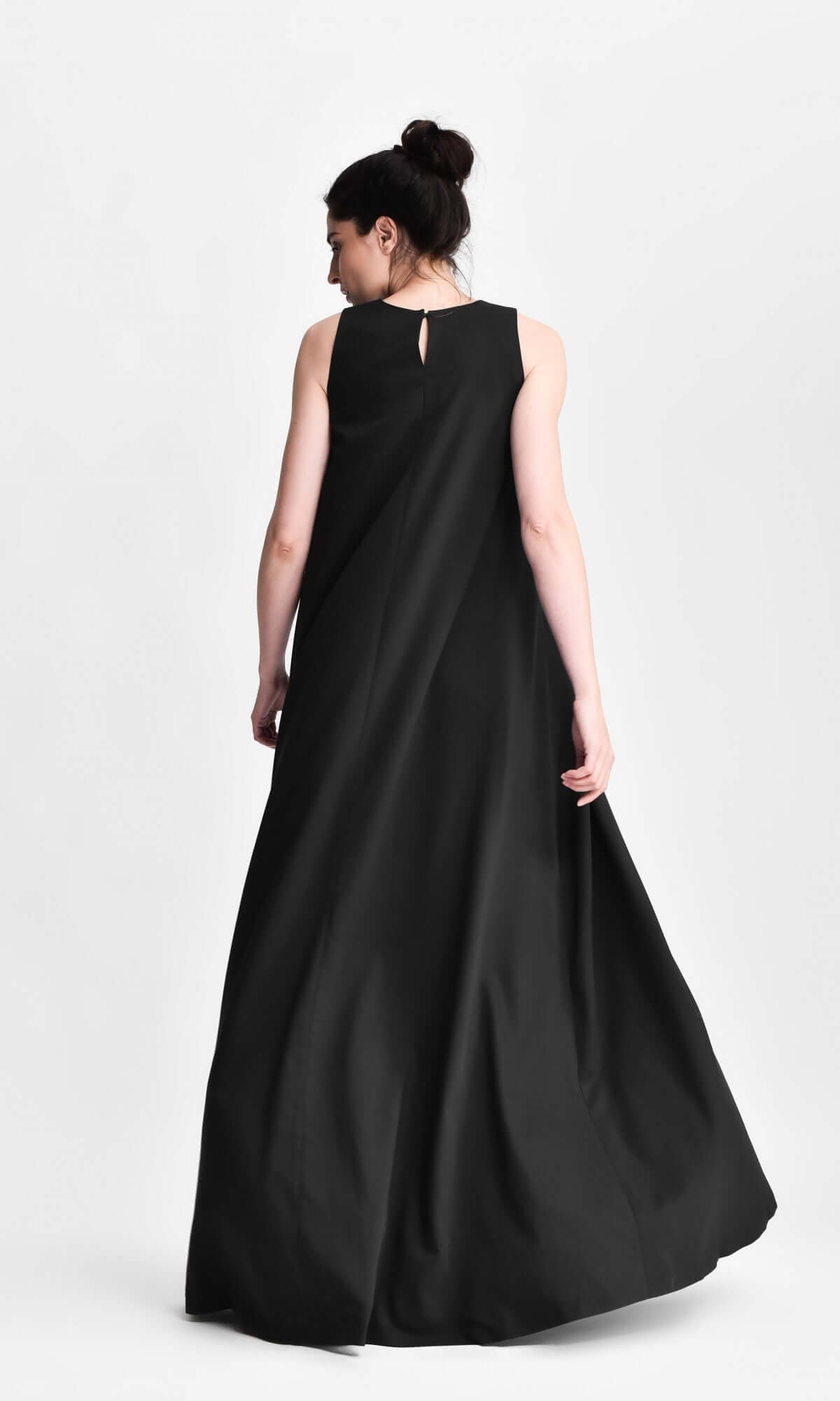 model walking in a flowing, sleeveless black floor-length dress
