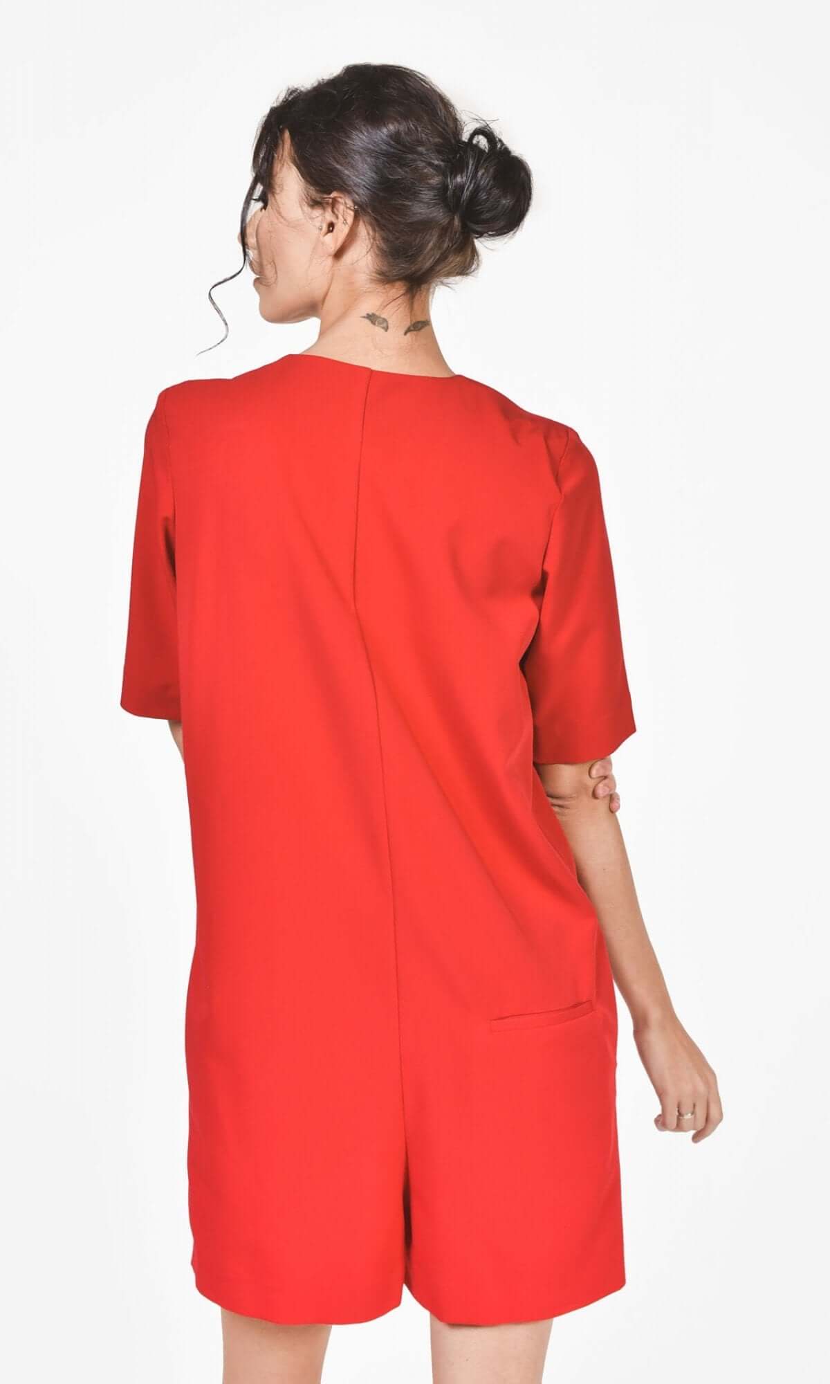 back side view of red short sleeve above knee loose fitted jumpsuit