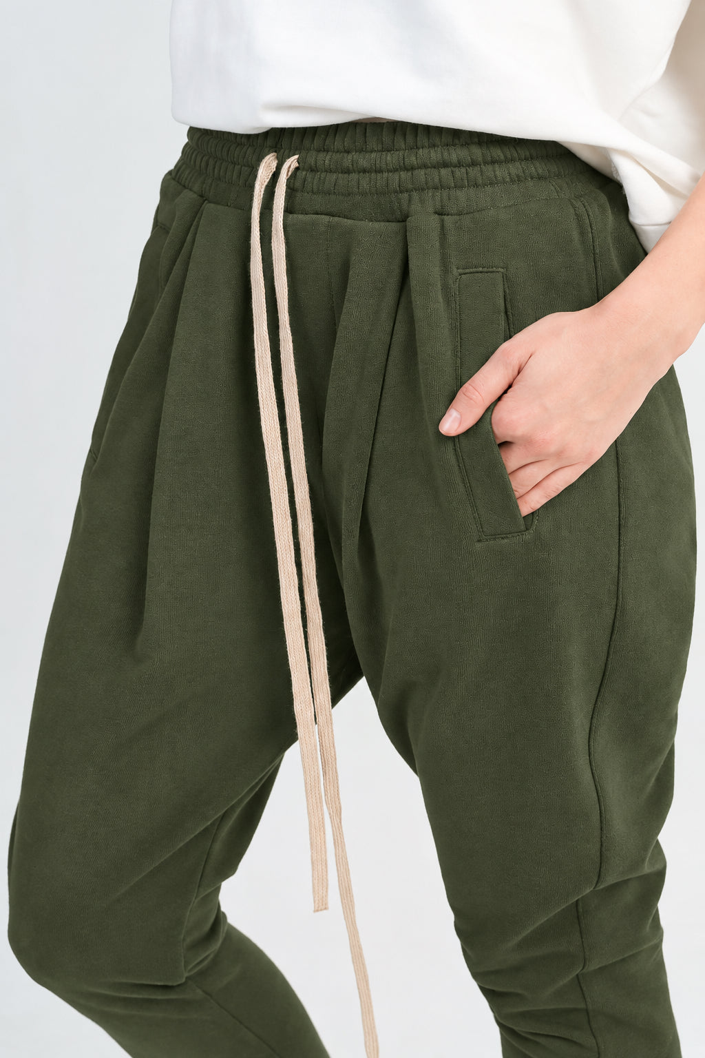 Black jogger pants with a beige drawstring, shown on a model wearing a white top against a light gray background.