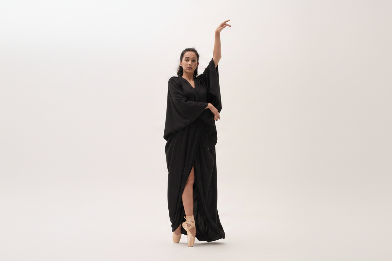 Black dress with skin-tone legs and nude ballerinas