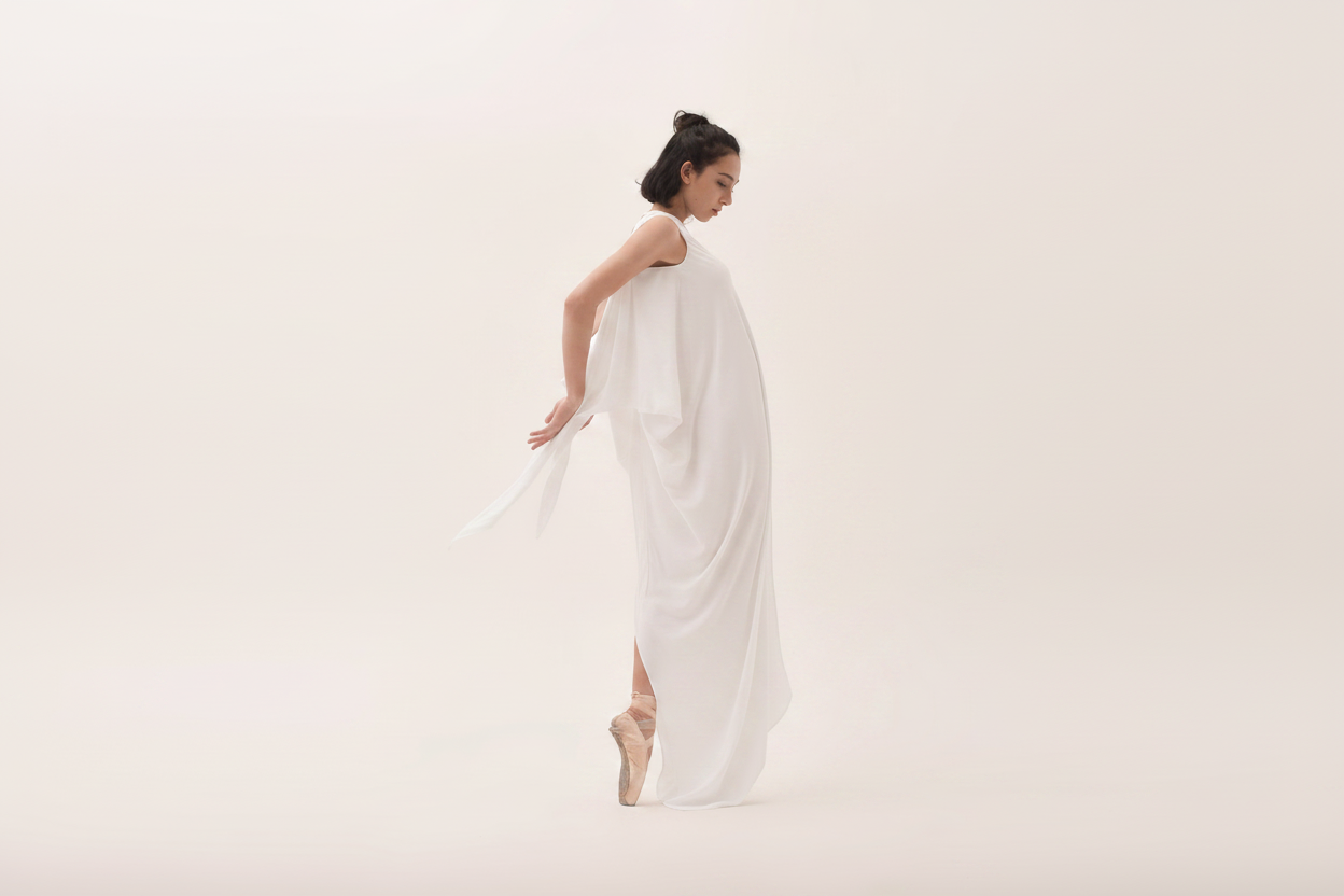 White draped dress with ballet pointe shoes
